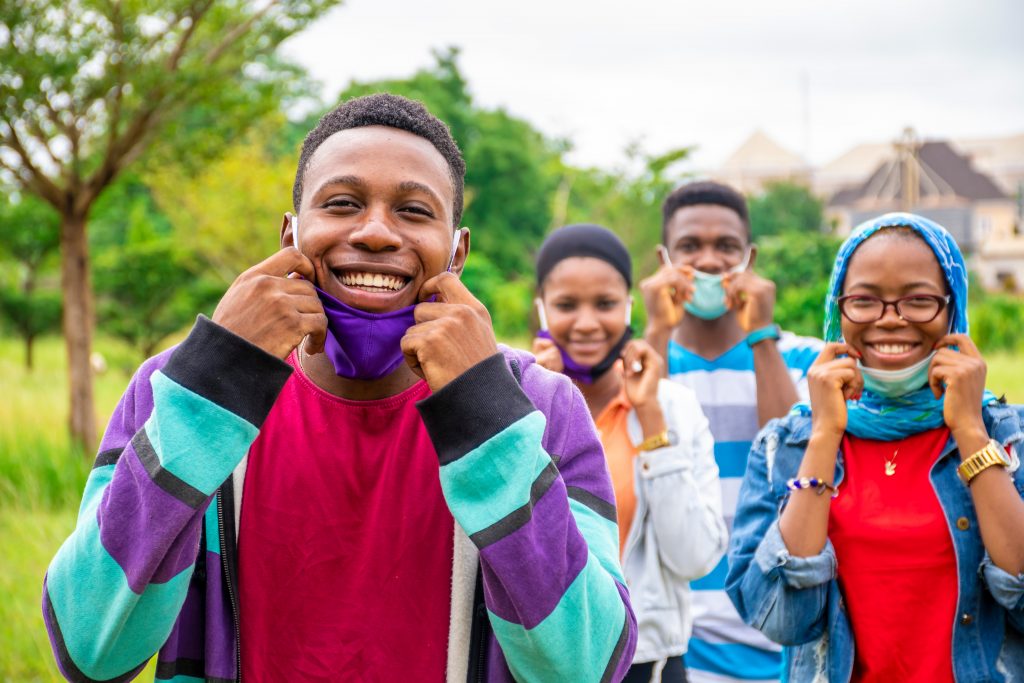 young african people wearing face masks, with physical distancin